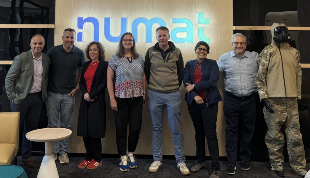Group of people with numat sign